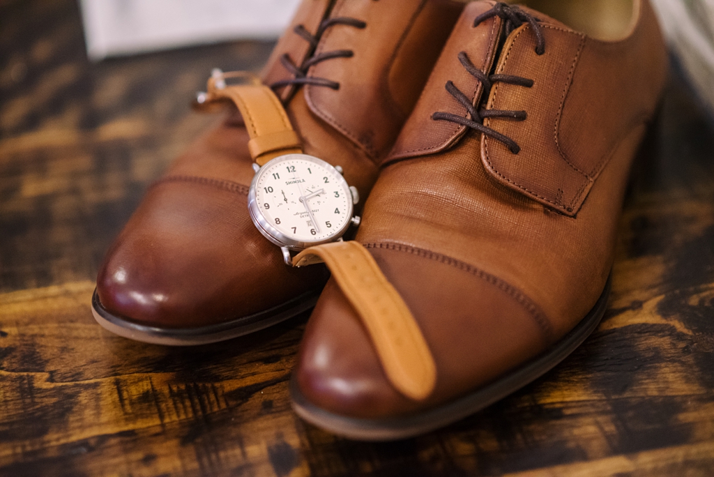 detail of groom's watch on his shoes