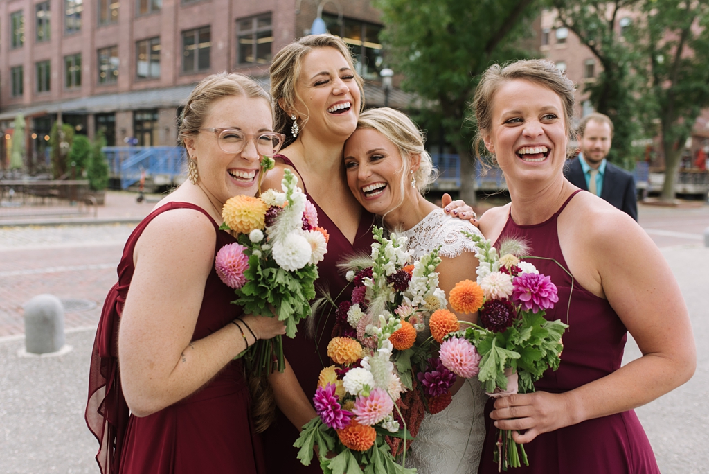bride laughs with bridesmaids downtown minneapolis
