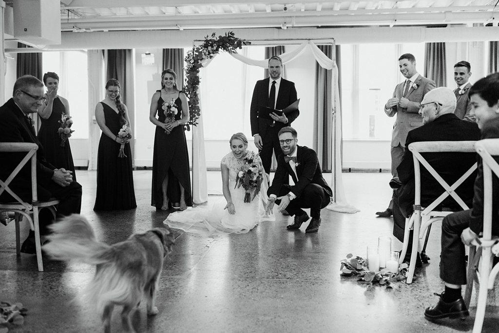 couple's dog as ring bearer at machine shop wedding