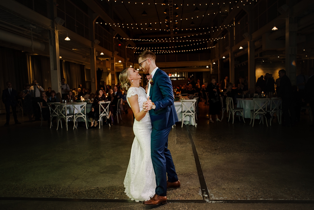 newlyweds share first dance at machine shop in minneapolis