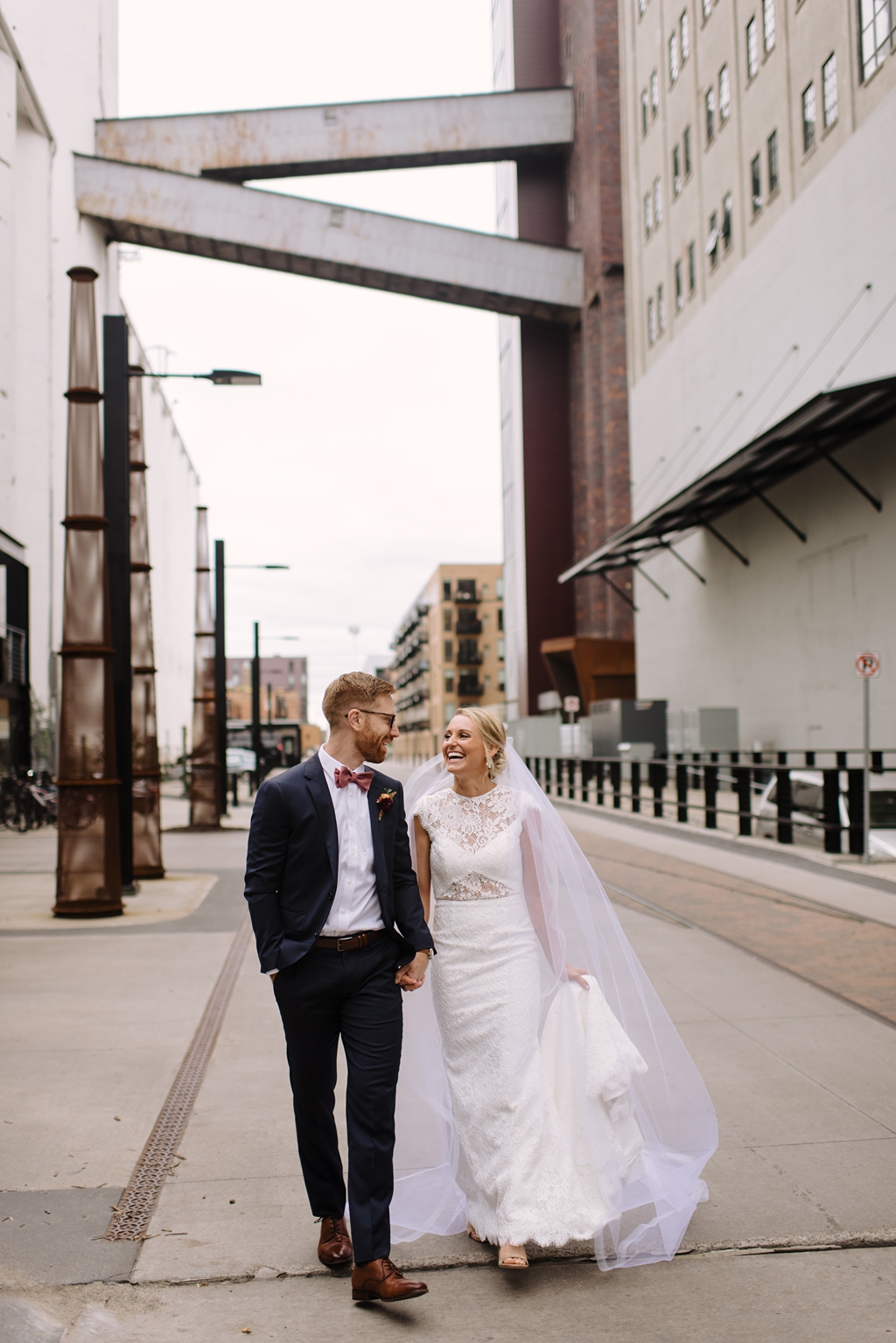 bride and groom walking in industrial setting