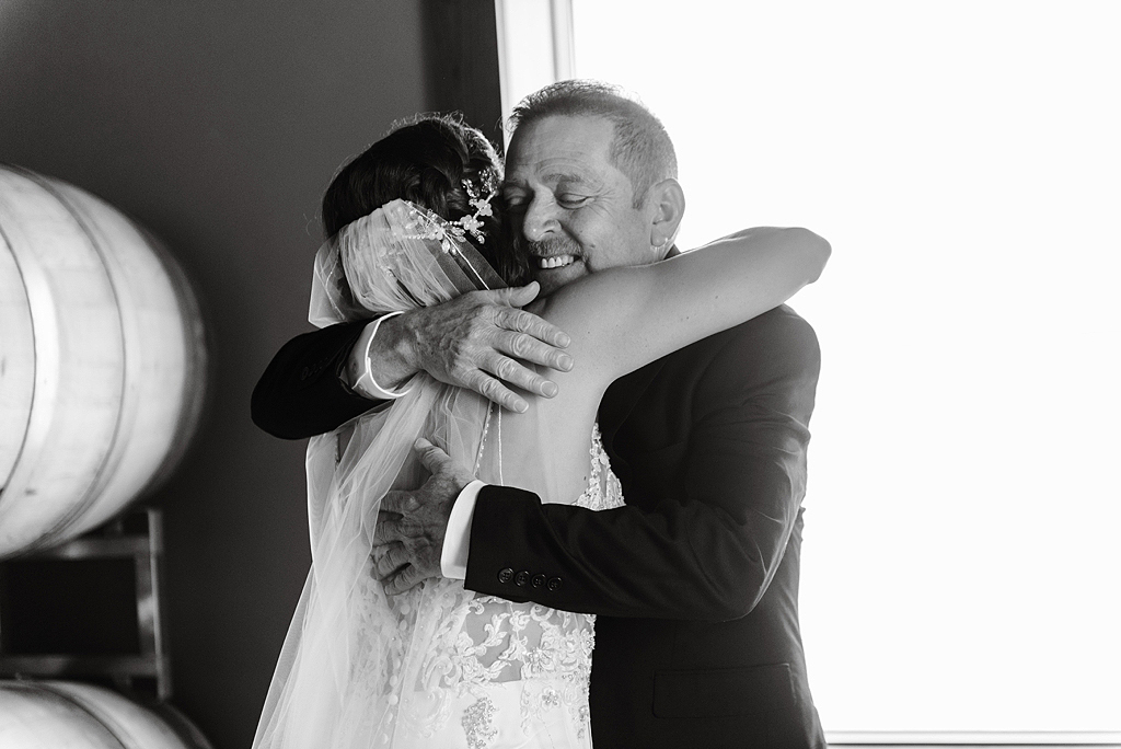 bride hugging her father before wedding