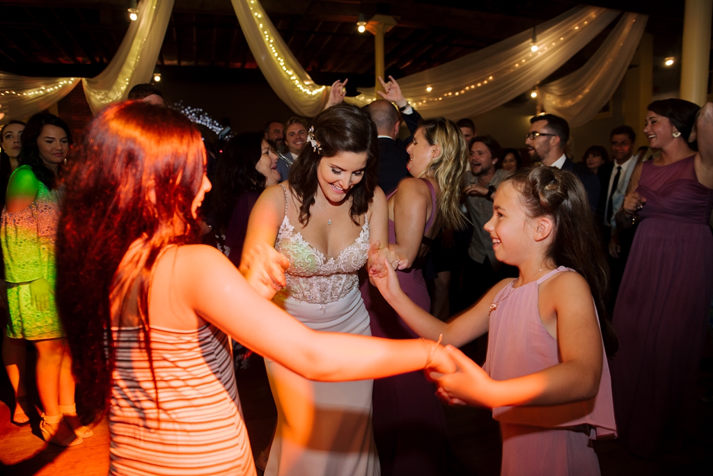 bride dancing with children at wedding reception