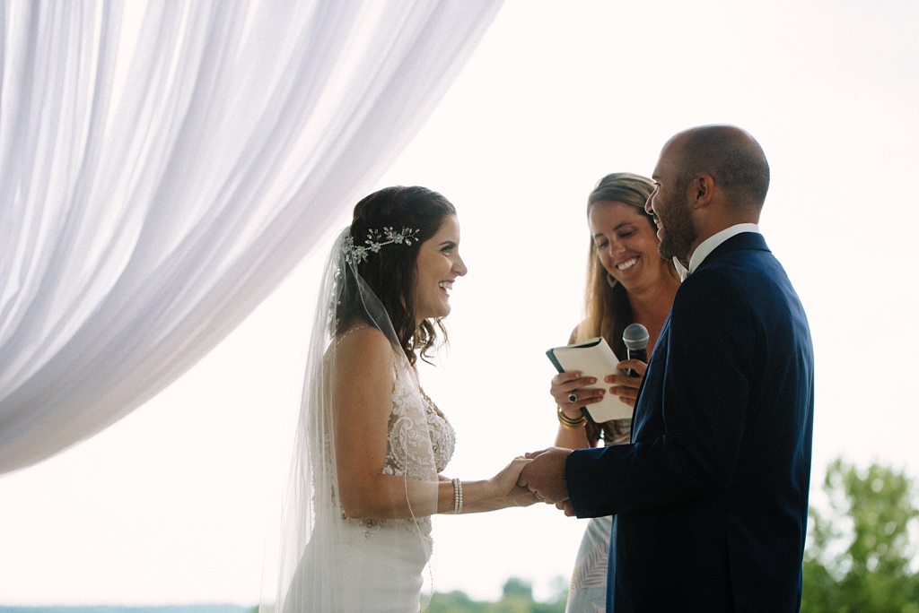 exchanging vows at cannon river winery wedding
