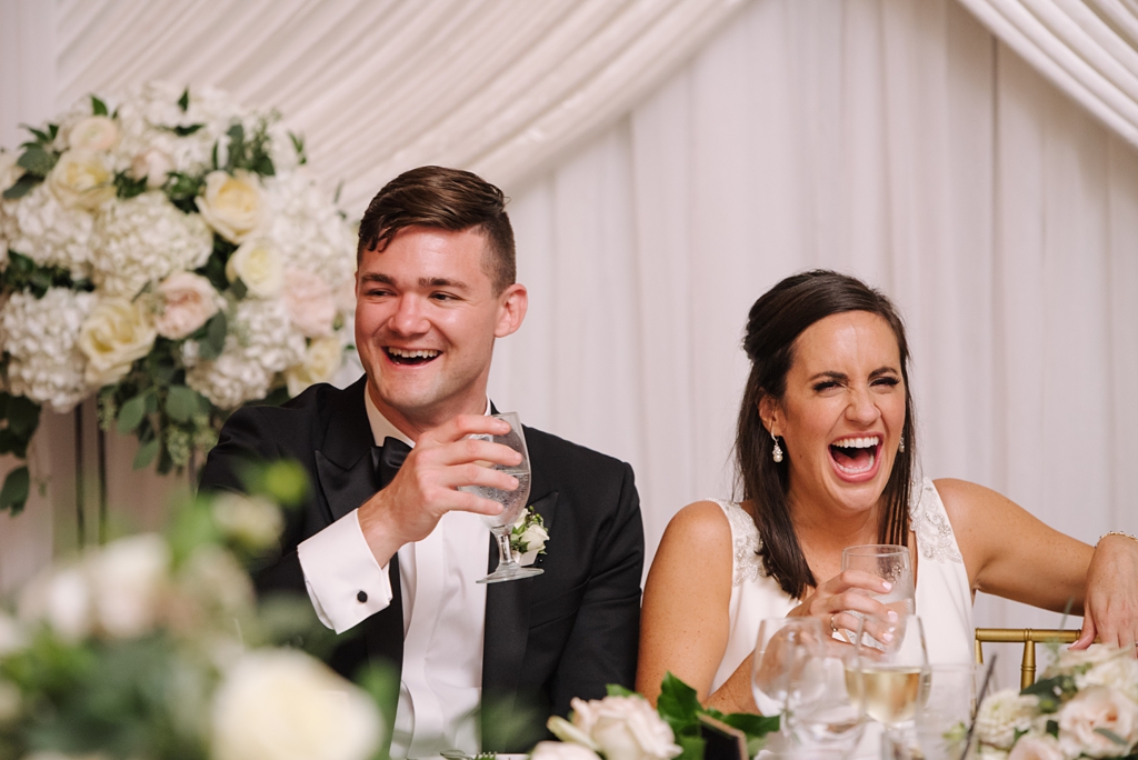bride and groom react to toasts during lodge wedding reception