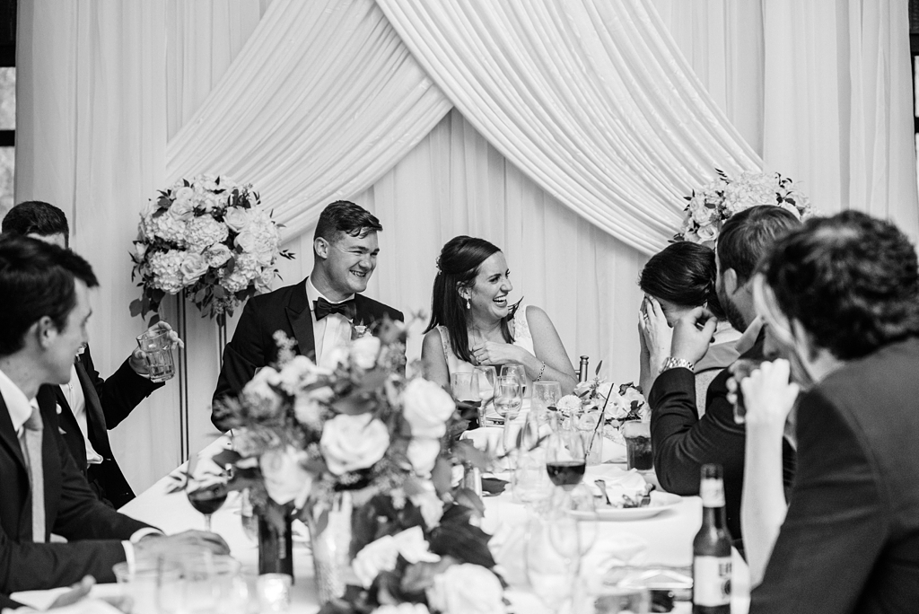 bride and groom react to toasts during lodge wedding reception