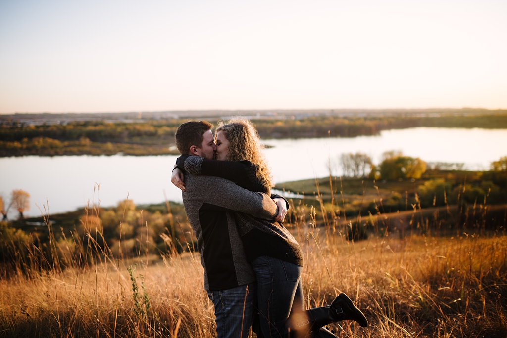 Couple hugging in prairie for their fall engagement photos