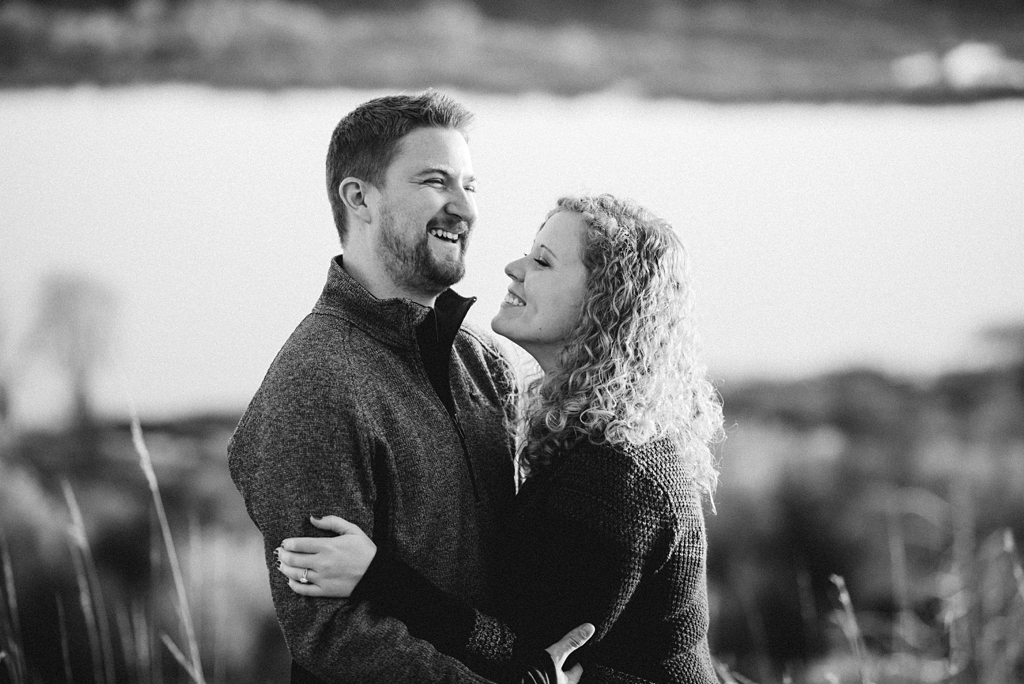 black and white photo of couple laughing together 