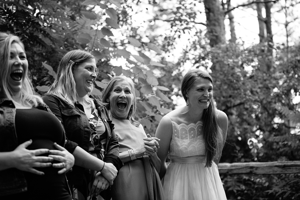 bride and guests laughing during camp wedding