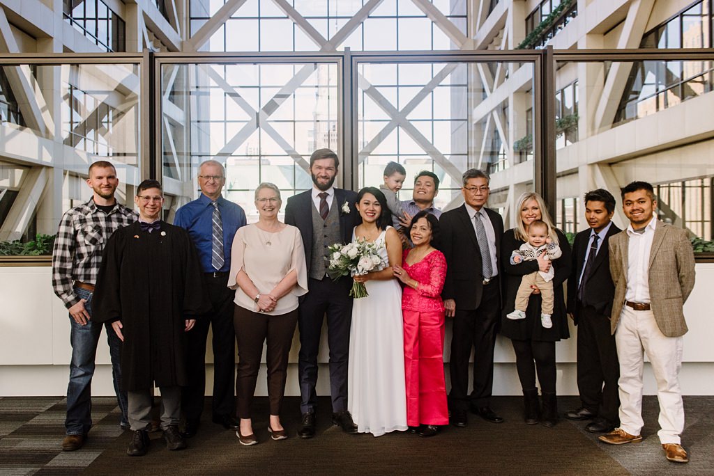 newlyweds with family and judge at courthouse wedding