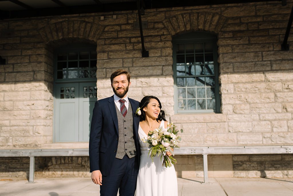 portrait of minneapolis newlyweds in front of stone building