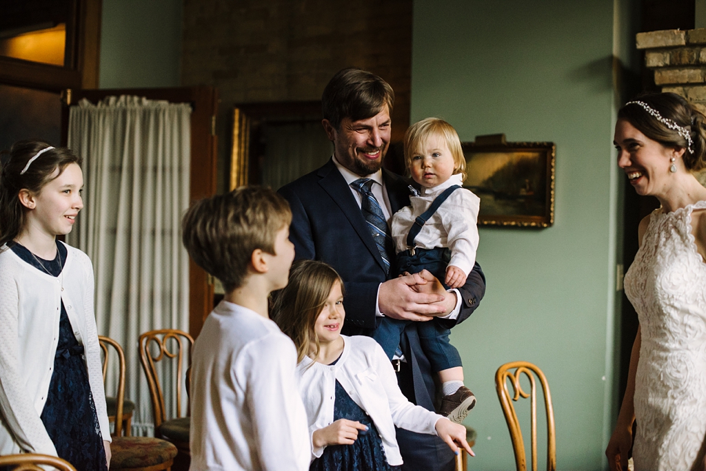 groom and children react to bride's dress