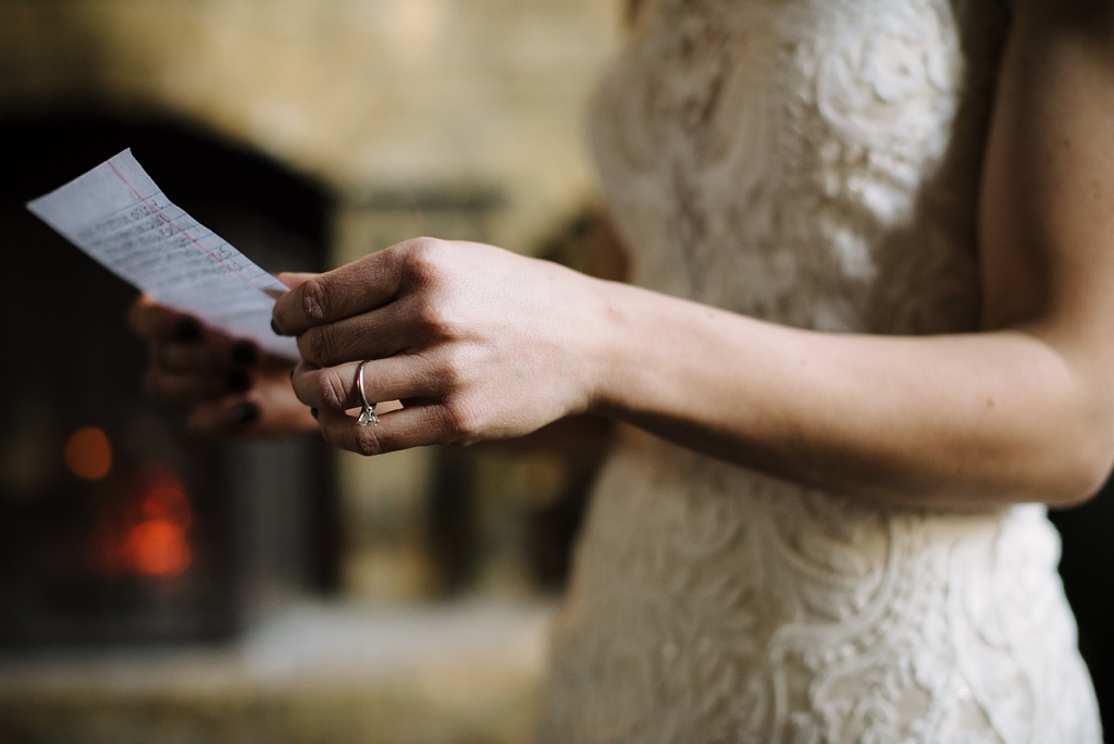 detail of bride's hands as she reads vows