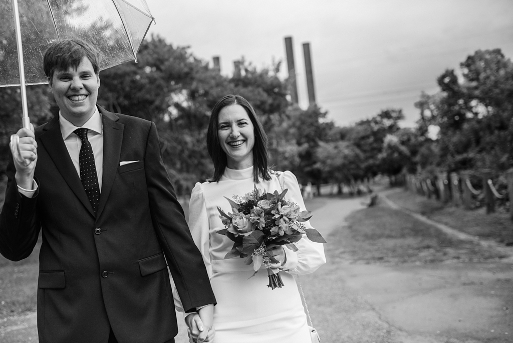 black and white photo of just married couple walking in minneapolis