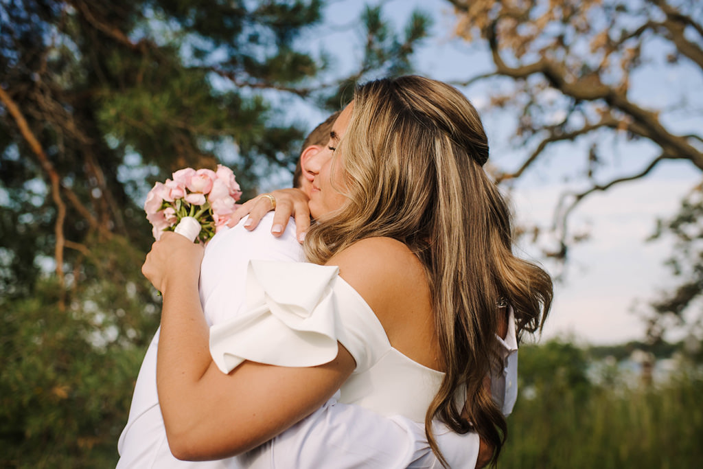 bride hugs groom after excelsior lake elopement