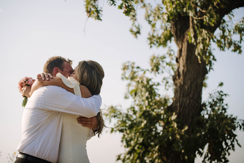 elopement wedding kiss beneath tree