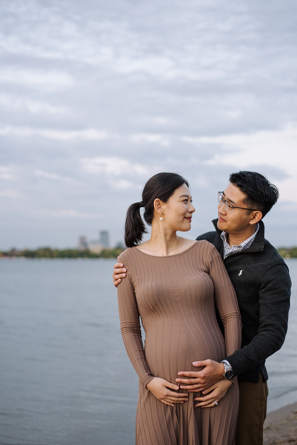expecting couple with minneapolis skyline behind