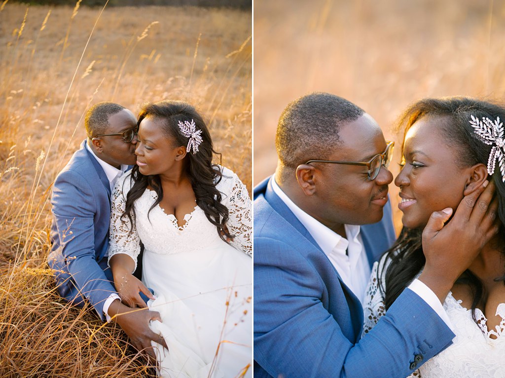 newlywed couple sits in golden field and kisses