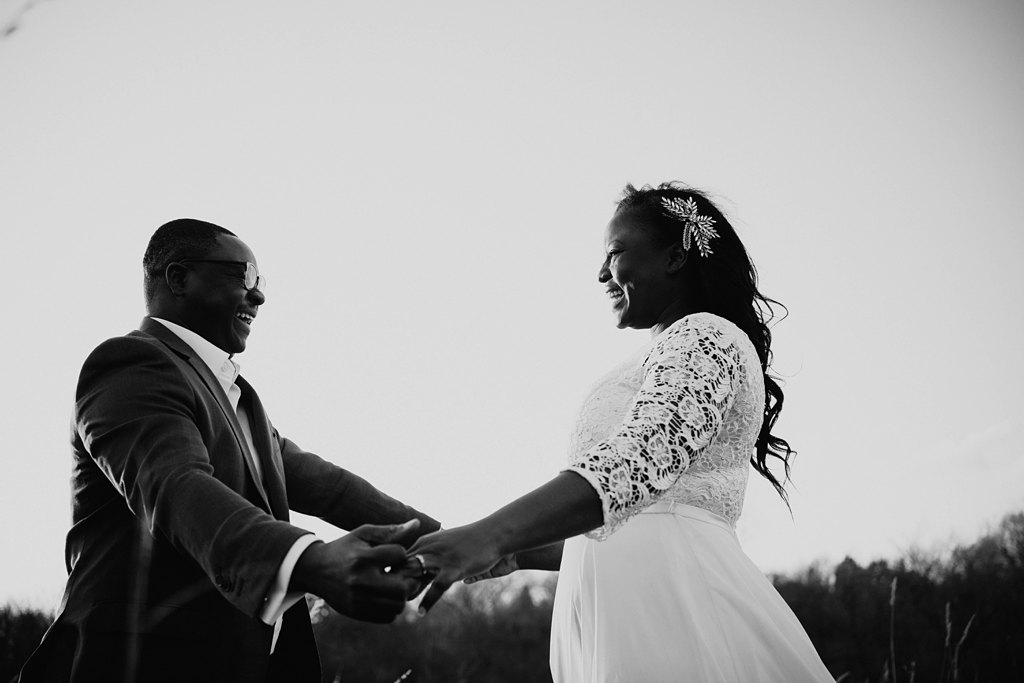 newlywed couple dancing outside in black and white
