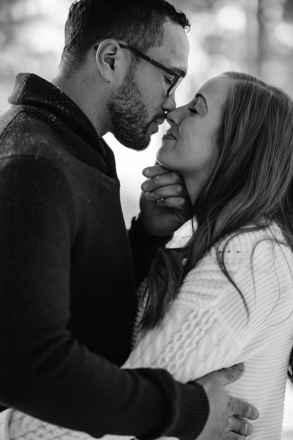 engaged couple bunny kiss in black and white