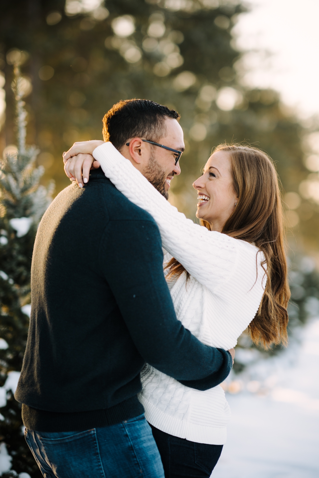 engaged couple hugging and smiling during engagement session