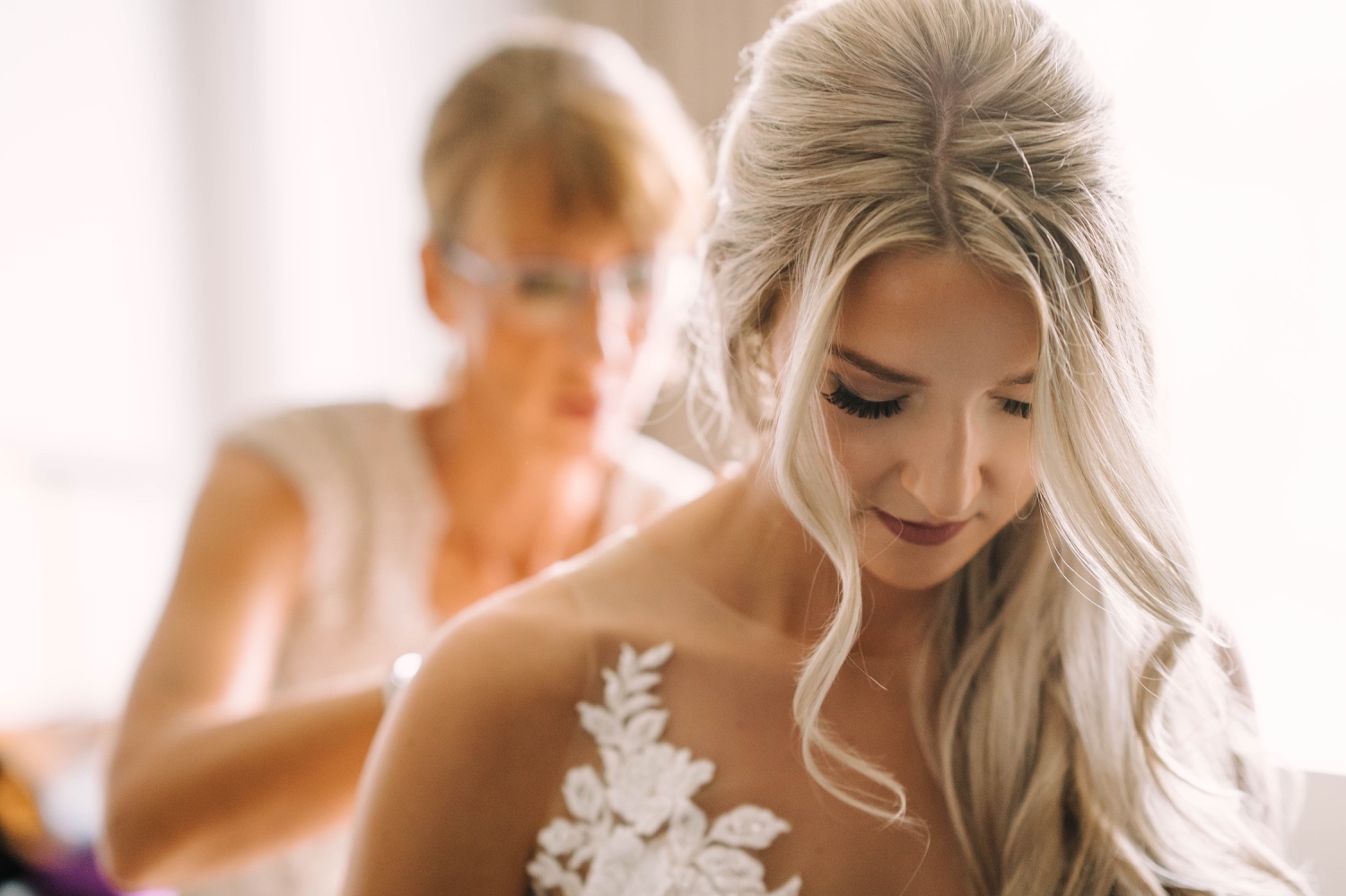 closeup of bride getting dressed at minnesota valley country club