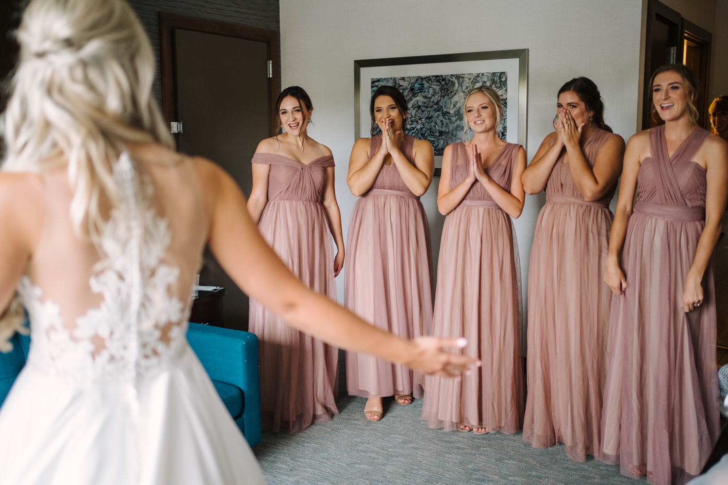 bridesmaids reacting to bride's wedding dress