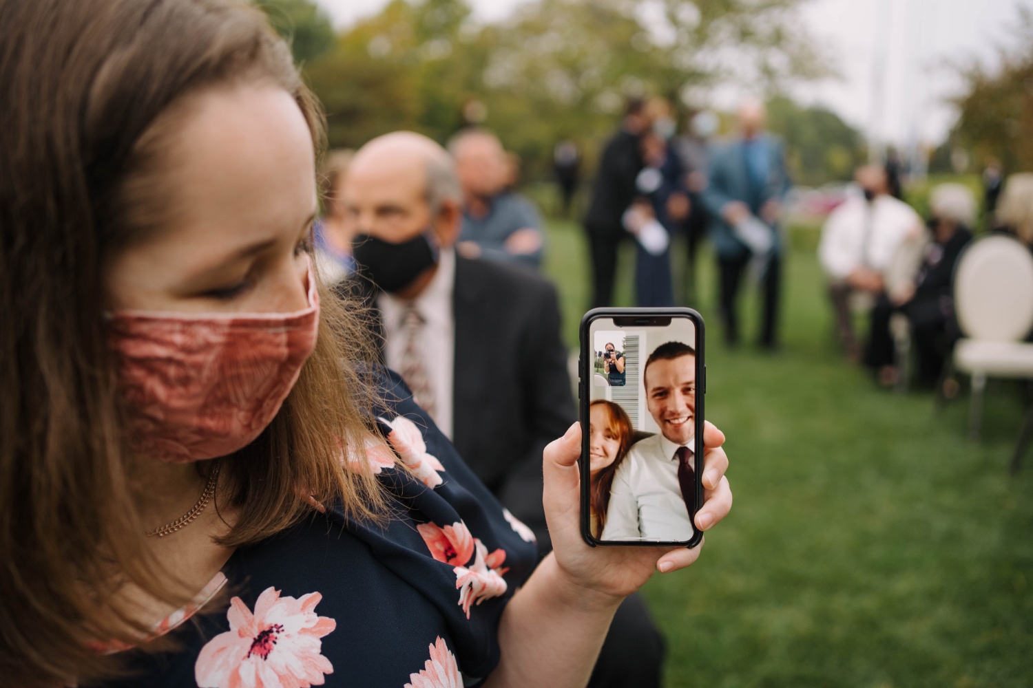 socially distanced wedding guests facetiming