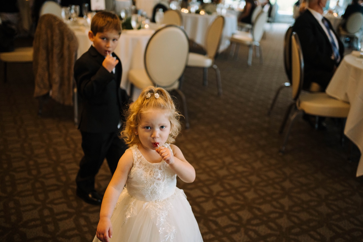 children eating suckers at wedding reception