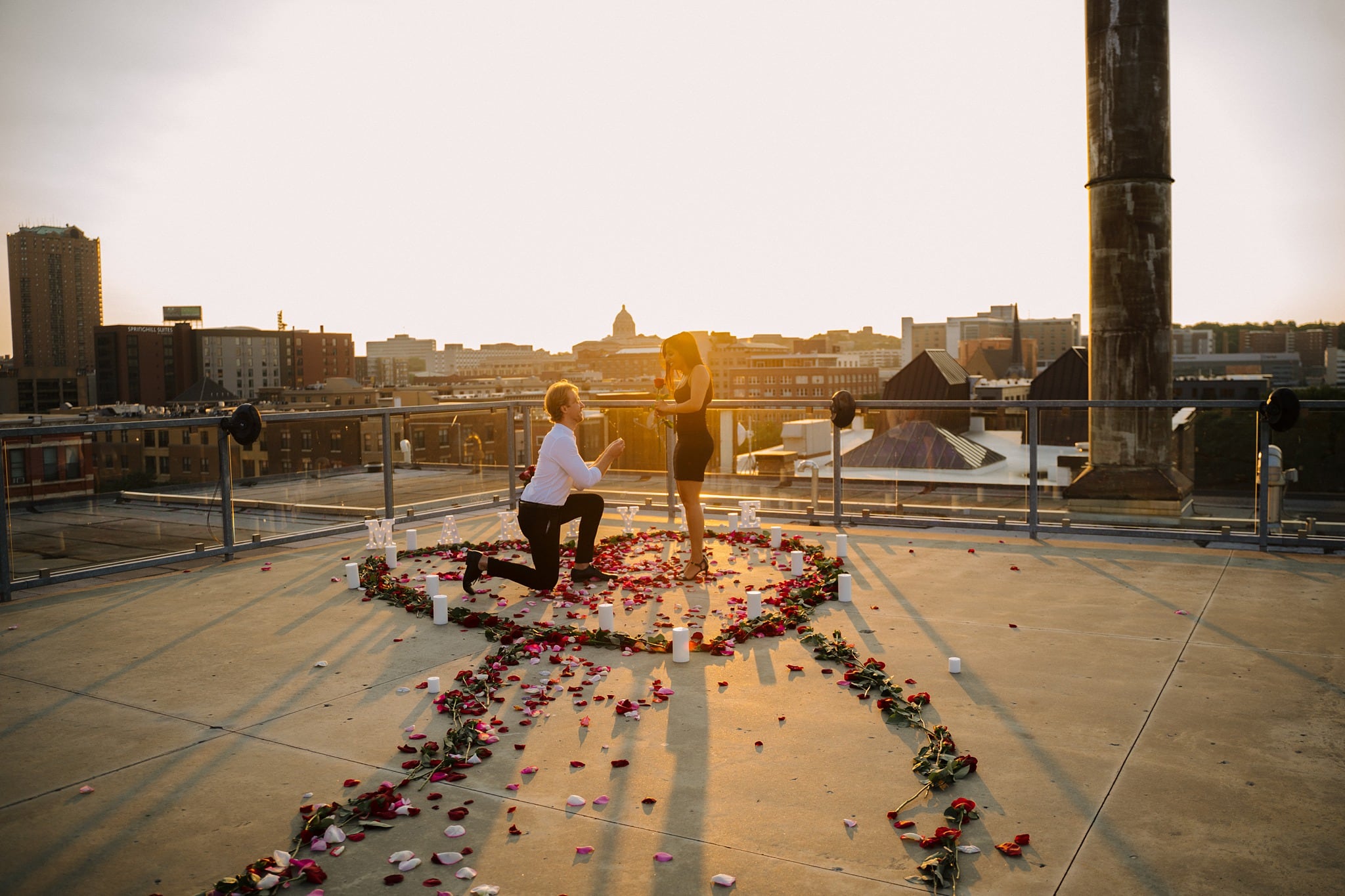 sunset rooftop proposal with roses