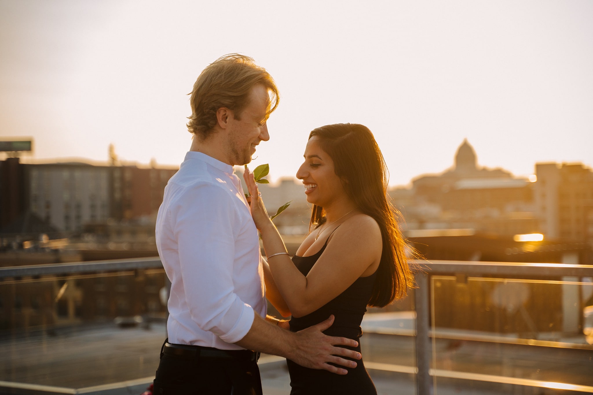 newly engaged couple admiring ring after A'bulae rooftop proposal
