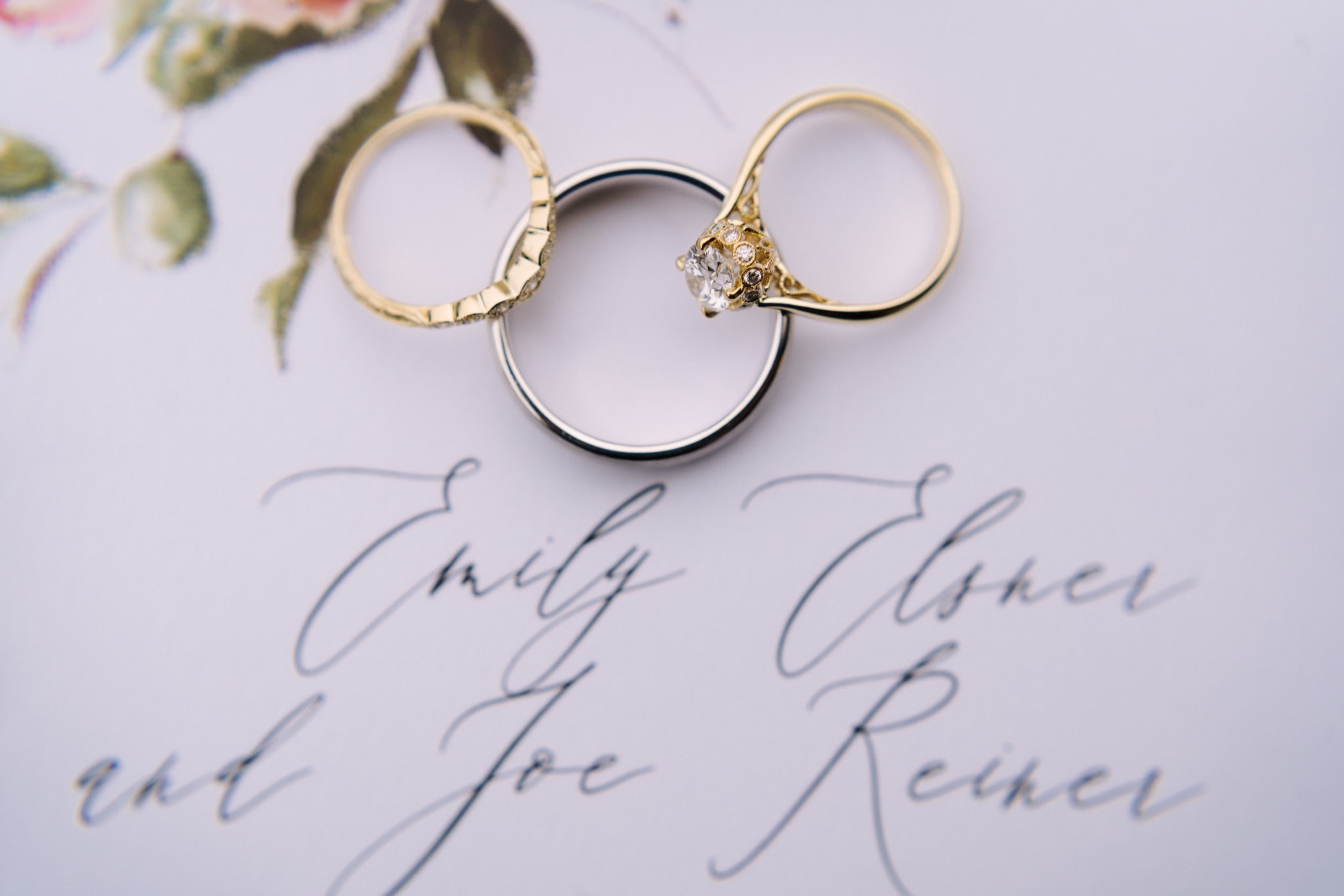 wedding invitation detail with wedding and engagement rings