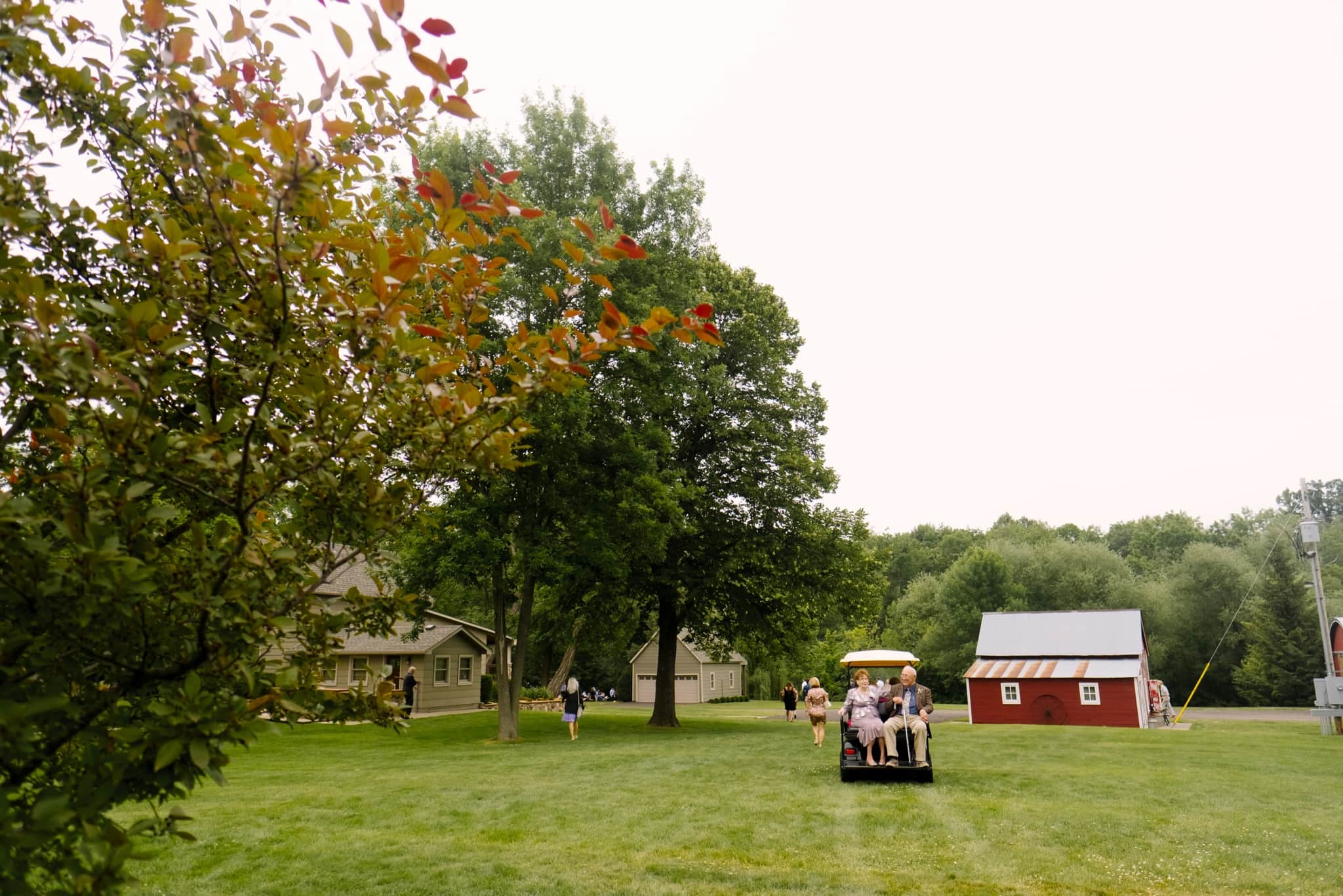 guests traveling to ceremony at farm wedding