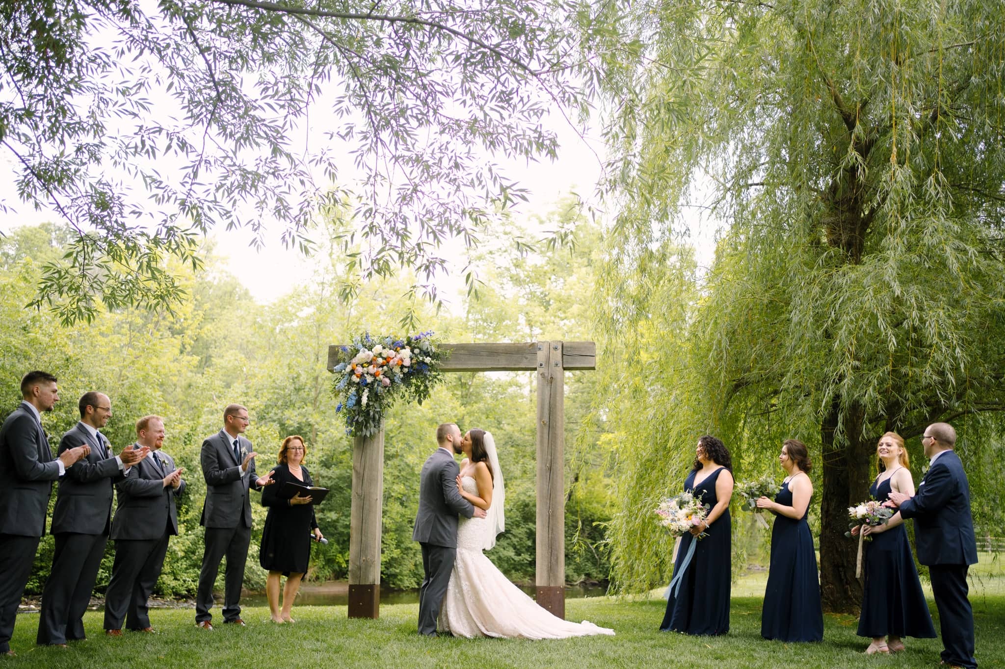 creekside farm outdoor wedding ceremony first kiss