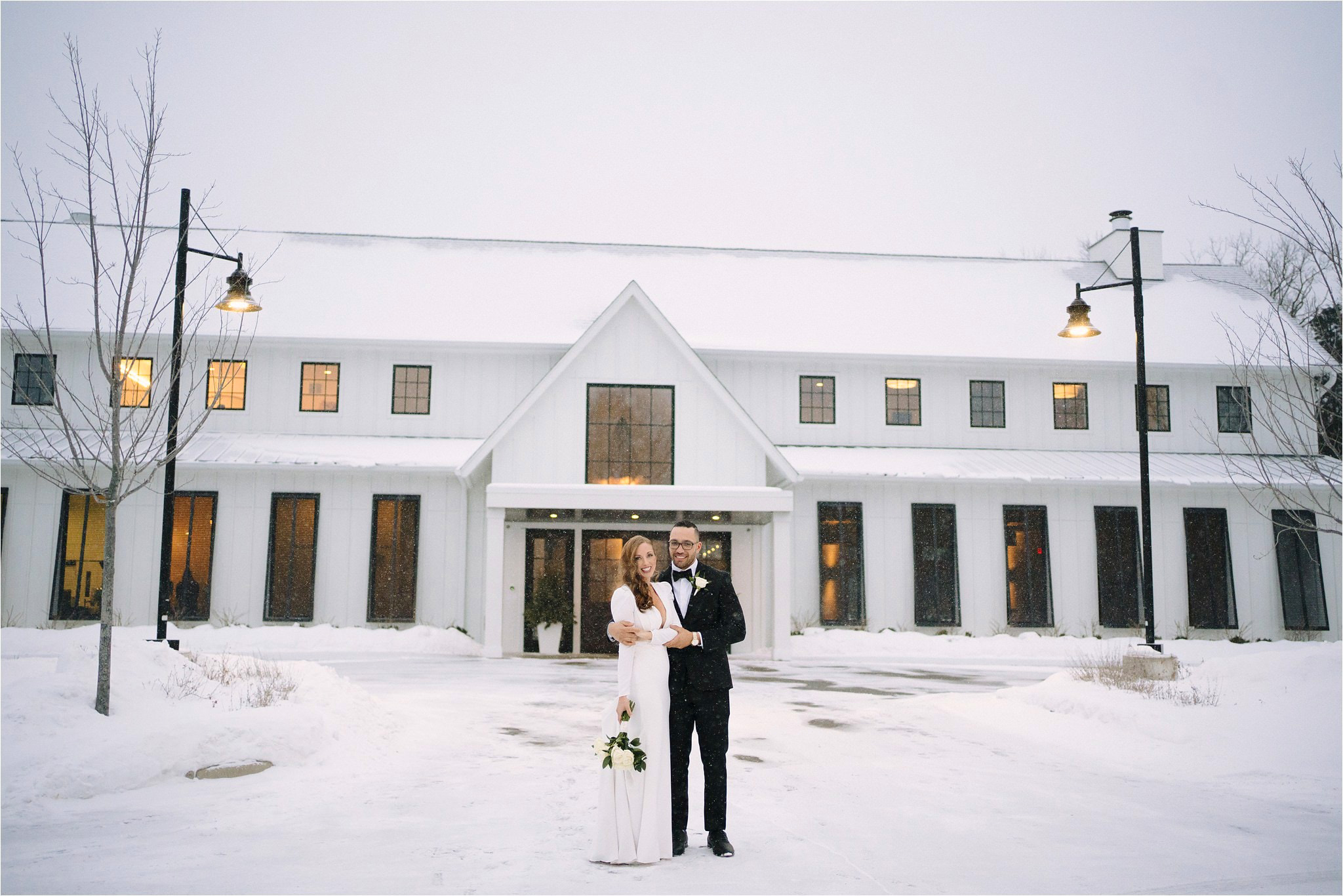 Couple posing in front of their Hutton House Wedding