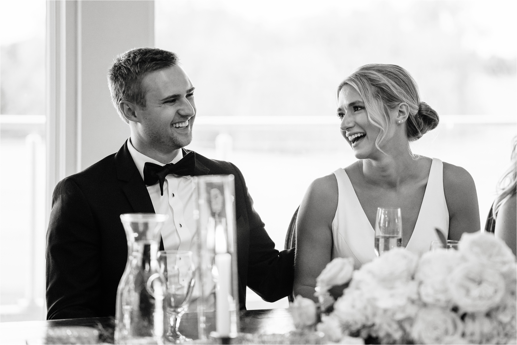 Recently married couple laugh during their reception toasts in Minneapolis