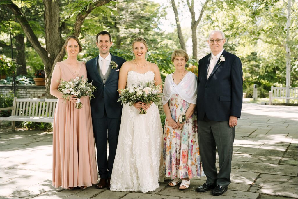 Bride and groom with bride's, mother, father and sister, family wedding portraits at Minneapolos wedding