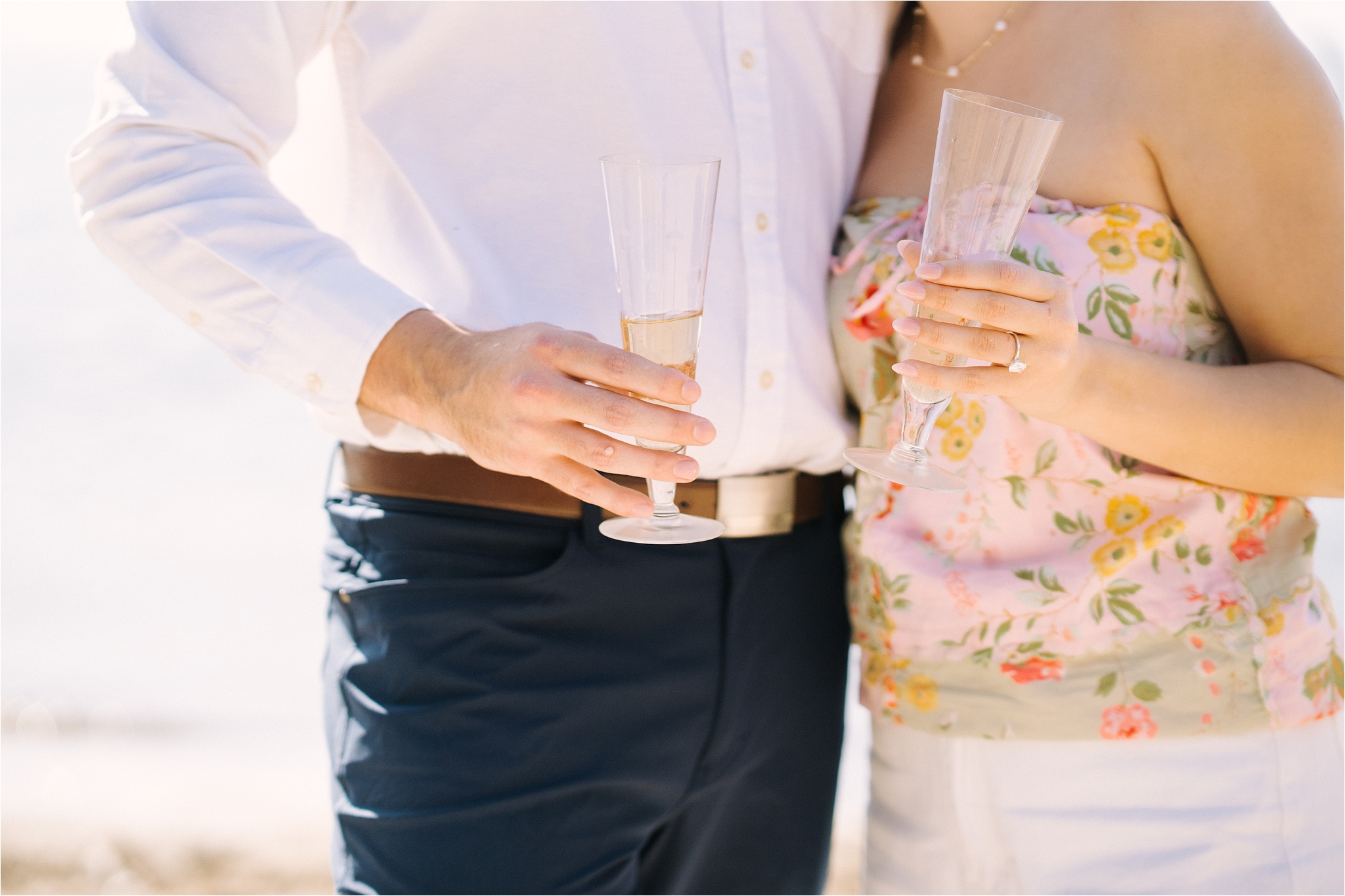 Couple holding champagne glasses after getting engaged