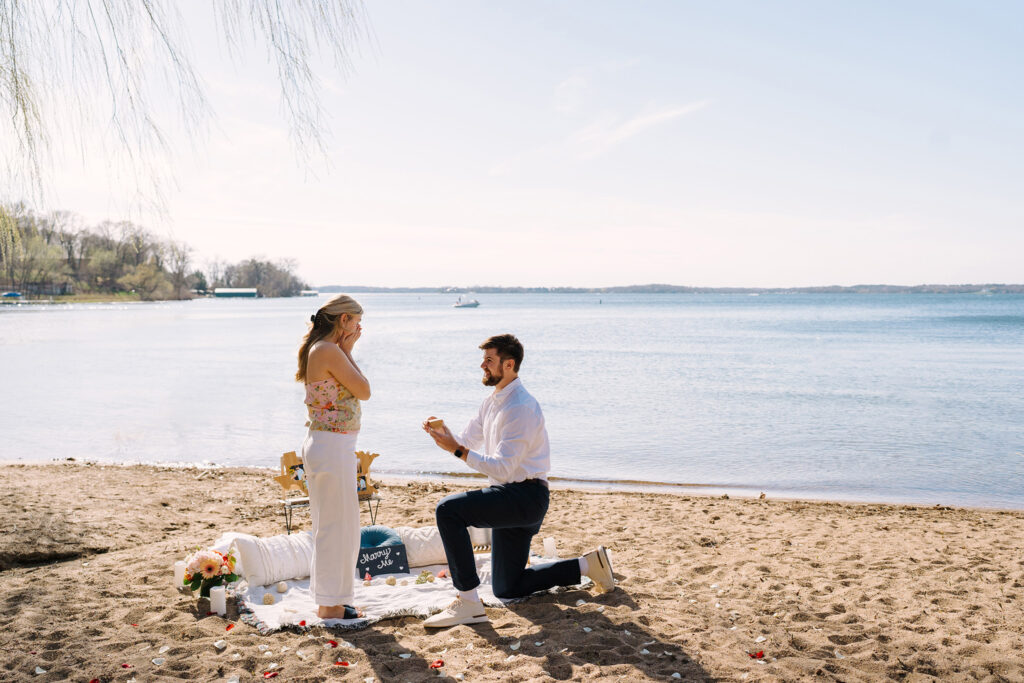 Marriage proposal on the beach with a picnic