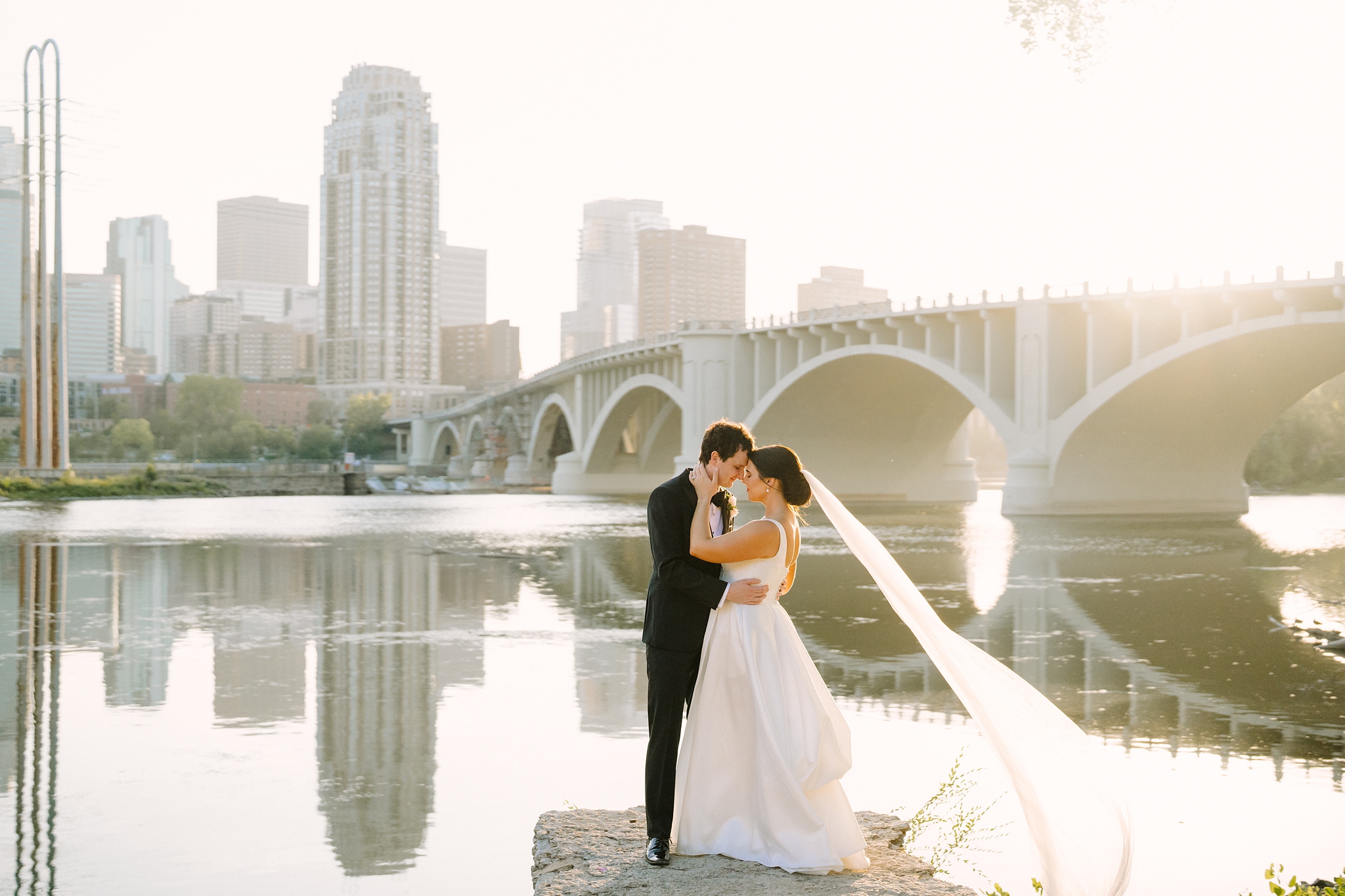 Couple embracing in front of the Minneapolis Skyline