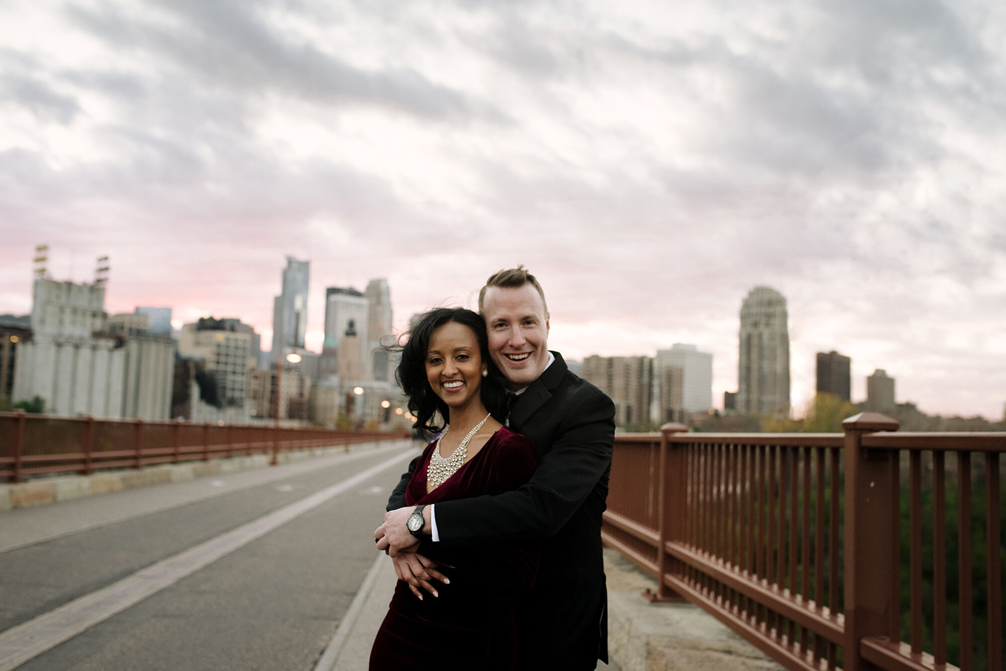 Happy couple embracing in the middle of the Stone Arch Bridge in Minneapolis